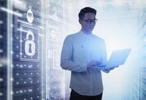 Young,Asian,Man,In,Glasses,Using,Laptop,Computer,In,Server